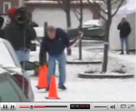 [Drew Peterson putting orange cones in driveway to keep the Stacy Peterson vigil group from parking in his driveway]