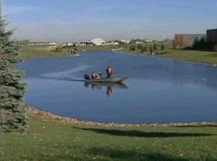 [Searchers and Divers at pond near Clow International Airport where Drew Peterson claimed his wife Stacy left her car Sunday night and called him at 9PM to pick it up (Bolingbrook, Will County, Illinois) - Screen capture from myfoxchicago.com]