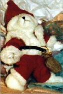[Red-and-white stuffed bear in a Santa suit]