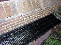 [Window Grate over Basement Window exterior]